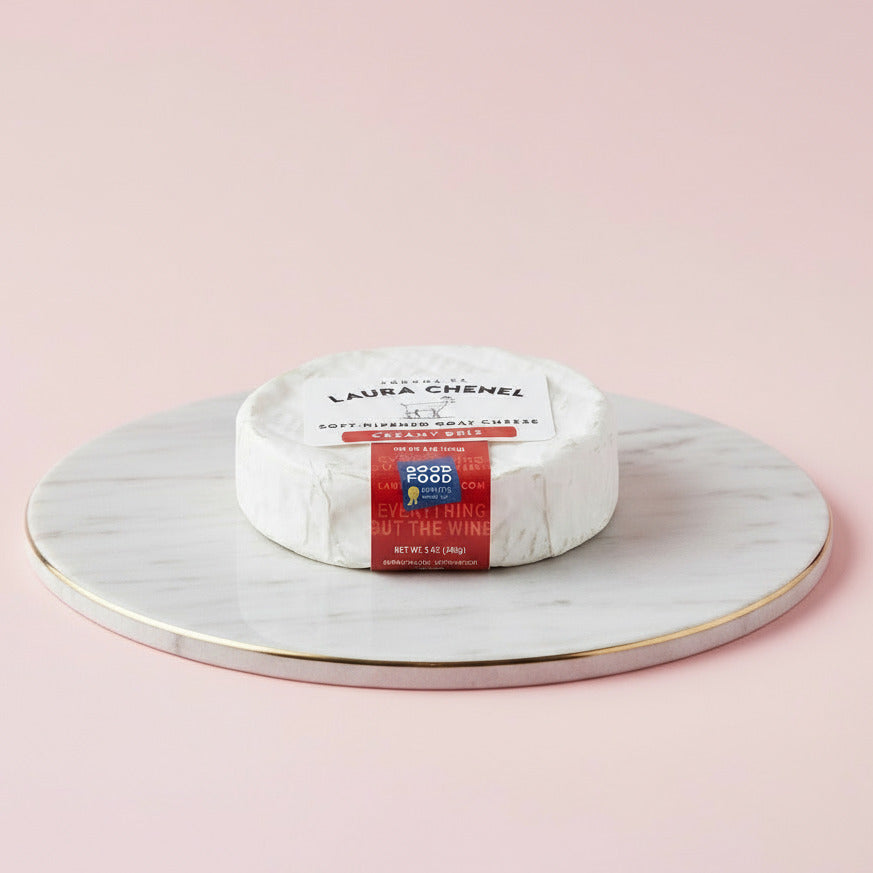 Goat cheese wheel with 'Laura Chenel' label on a white background