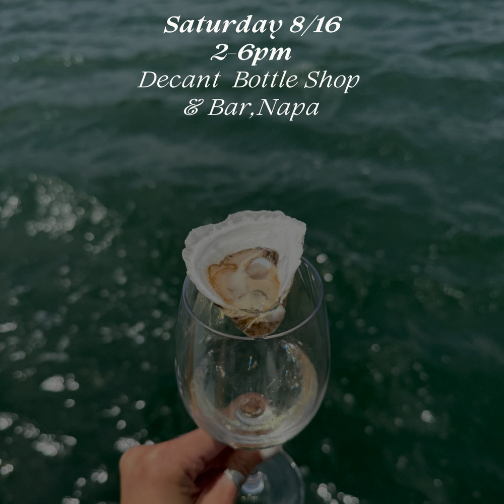 
                  
                    Hand holding a wine glass with an oyster against a body of water, promoting an event at Decant Bottle Shop & Bar, Napa.
                  
                