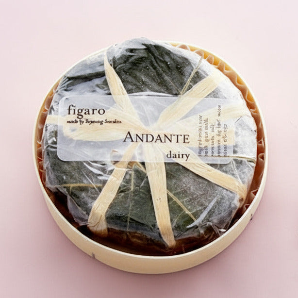 Packaged and sliced cheese on a marble surface with 'Figaro' branding.