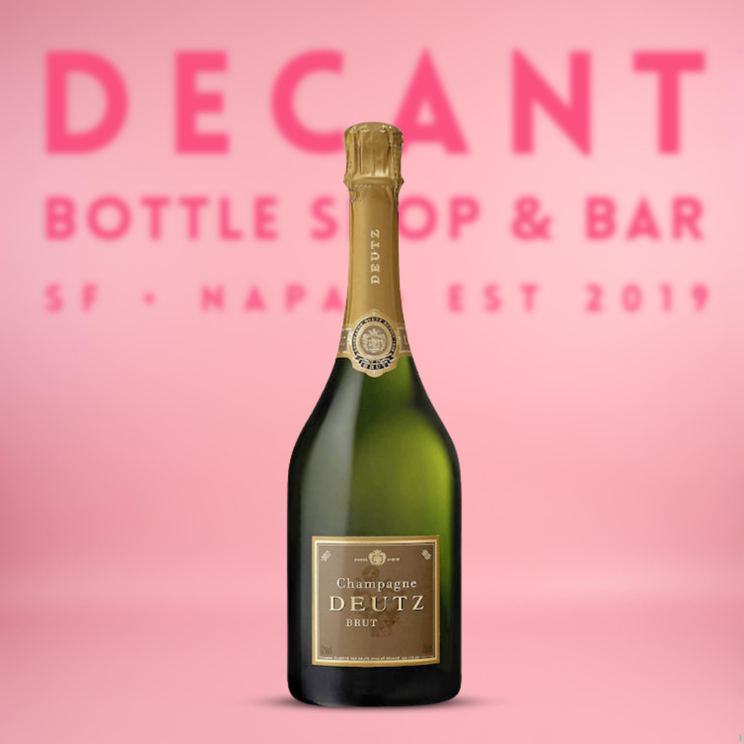 Deutz champagne bottle on a pink background with 'Decant Bottle Shop & Bar' text.