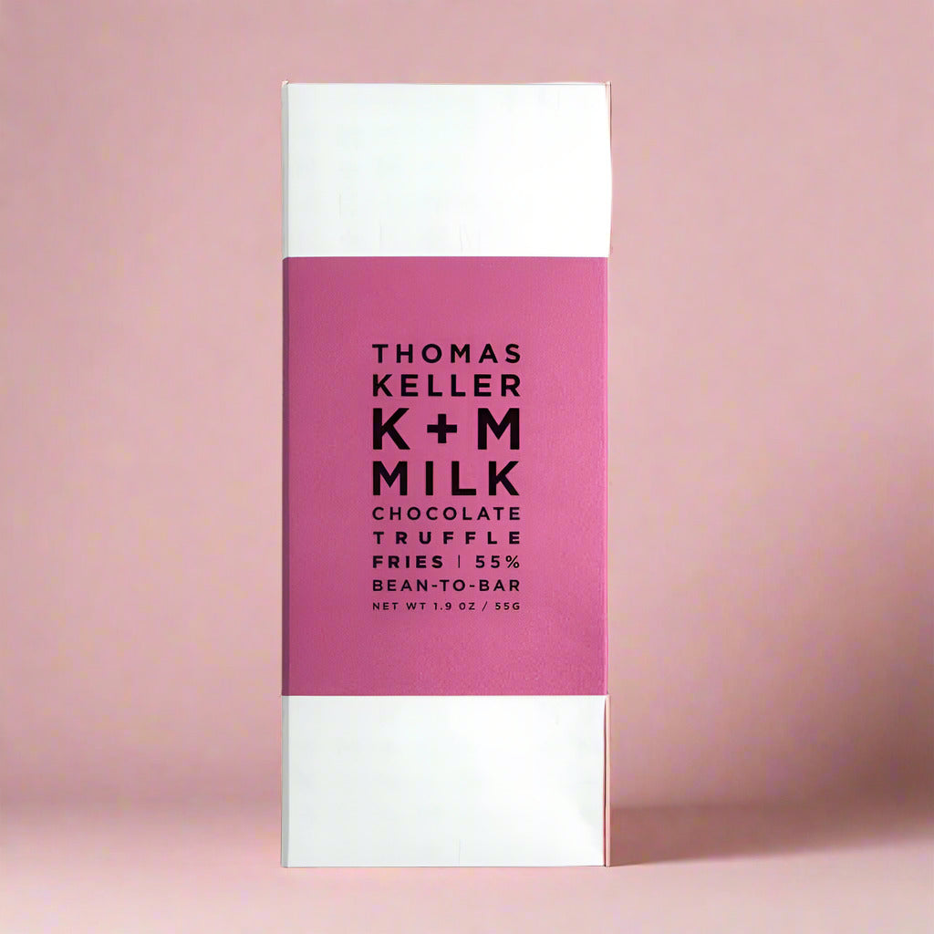 Chocolate bar packaging with pink and white design featuring 'Thomas Keller K+M Milk'.