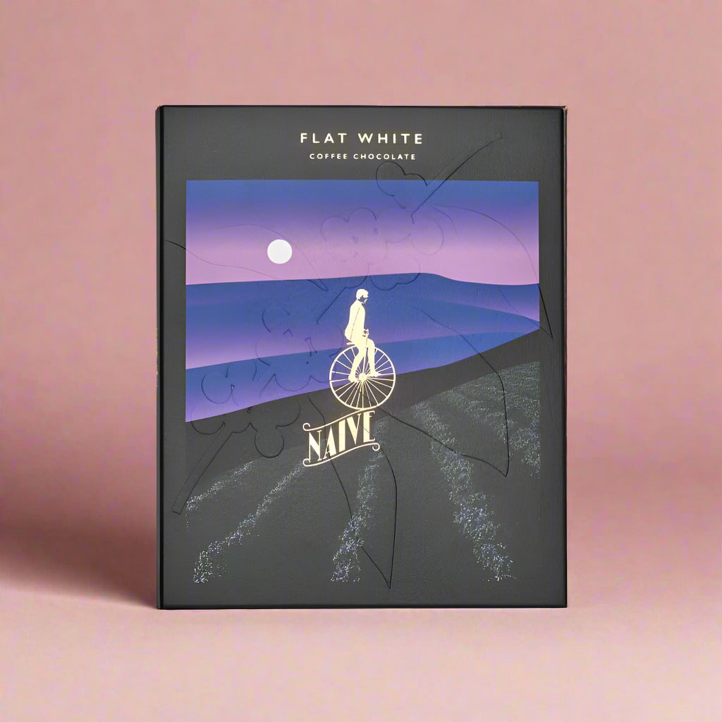 Chocolate packaging with a purple landscape design and 'Flat White' text