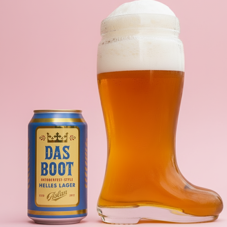 Glass boot filled with beer next to a can of 'Das Boot' beer on a wooden surface.