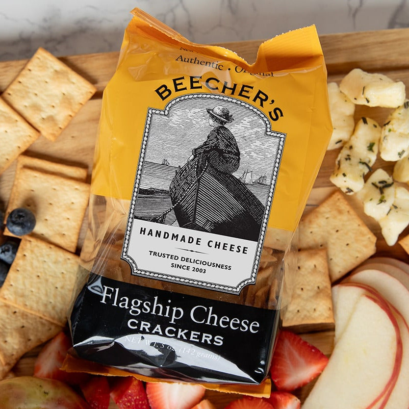 Beecher's Flagship Cheese Crackers on a platter with fruits and cheese.